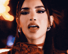 a close up of a woman 's face with her tongue hanging out