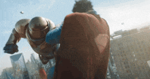 a man in a red cape is standing next to a man in a robot suit