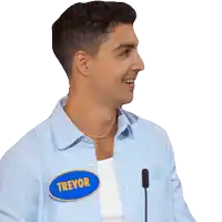 a man wearing a blue shirt with a name tag that says trevor