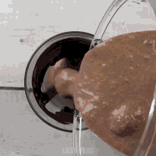 a glass of liquid is being poured into a bowl that says easy plus on the bottom