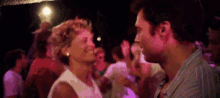 a man and a woman are kissing in a crowd of people .