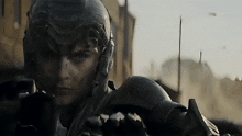 a close up of a person wearing a futuristic helmet