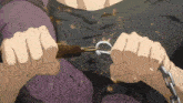 a person with a chain around their waist is holding a hook