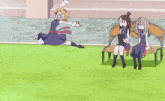 two girls sit on a bench while a girl stands in the foreground