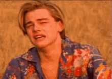 a young man in a blue shirt is crying .