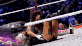 a woman in a wrestling ring with a new dynamite logo on the bottom