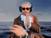 a man wearing a wig and sunglasses holds out his hand