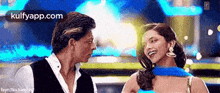 a man and a woman are looking at each other and laughing .