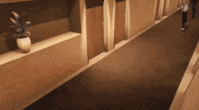 a man is walking down a hallway with a potted plant on the shelf .