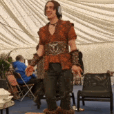 a man wearing a costume with a belt that says ' armour ' on it