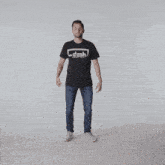 a man wearing a black shirt that says faith is kneeling on the floor