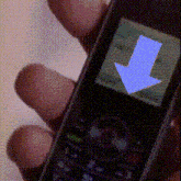 a person is holding a cellphone with a blue arrow pointing down