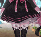a girl in a black dress with hearts on the straps
