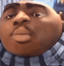 a close up of a cartoon character 's face with a huge head .