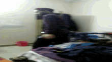 a blurry picture of a person laying on a bed with a bottle of water in front of them