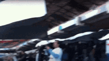 a blurry picture of a crowd of people holding umbrellas in the rain