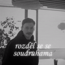 a black and white photo of a man and the words rozdel se se soudruhama