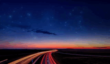 a sunset over a highway with a lot of lights