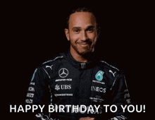 a man in a mercedes shirt is smiling and giving a thumbs up while saying happy birthday to you