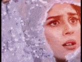 a close up of a woman 's face covered in water