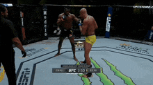 two men are fighting in a boxing ring with the ufc logo on the side