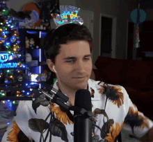 a man wearing a happy new year 's eve headband stands in front of a microphone