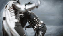 a man in a knight 's armor is kicking another man