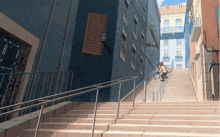 a man walking up a set of stairs with a bucket in his hand