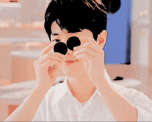 a person holding a cookie in front of their eyes with a watermark that says celestnt