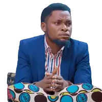 a man wearing a blue jacket and striped shirt is sitting on a polka dot chair
