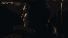 a close up of a woman 's face in a dark room with the hashtag jackryan on the bottom