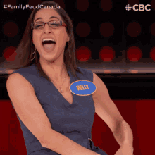 a woman in a blue dress with a name tag that says kelly