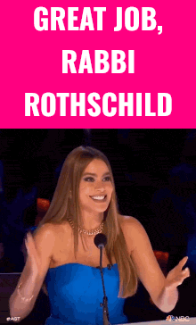 a woman in a blue dress is smiling in front of a pink sign that says " great job rabbi rothschild "