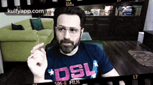 a man with a beard and glasses is wearing a shirt that says dsl on it