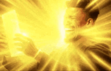 a man is crying while holding a piece of paper in front of a bright yellow light .