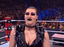 a woman in a wrestling ring with the word live on the bottom right corner