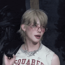 a person wearing sunglasses and a shirt that says squared