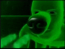 a close up of a green monster 's face with a glowing nose and mouth .