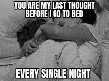 a black and white photo of a couple hugging in bed with a quote .