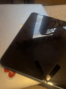 a ceiling fan is reflected in a tablet 's screen