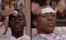 a man in a hospital gown is getting a bandage on his head .
