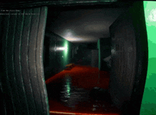 a hallway with a green wall and a red floor