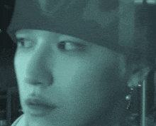 a close up of a person 's face with a bandana on their head