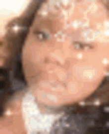 a close up of a woman 's face with sparkles on her face .