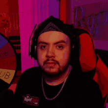 a man wearing headphones gives the middle finger