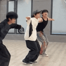 a group of young men are dancing together in a room