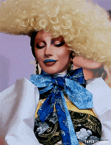 a close up of a woman wearing a wig and a blue scarf with the words tayce tumblr below her