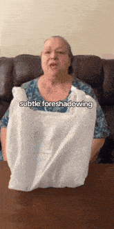 a woman is holding a white plastic bag that says subtle foreshadowing on it