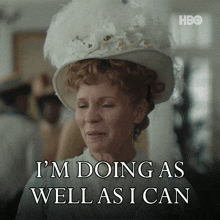 a woman wearing a white hat with the words i 'm doing as well as i can