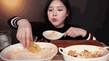 a woman is sitting at a table eating food